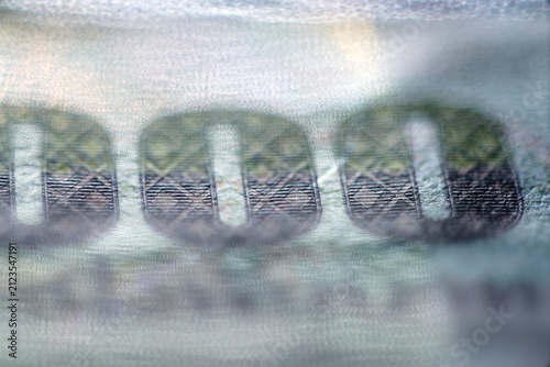 Extreme closeup macro of money currency security thread detail texture pattern