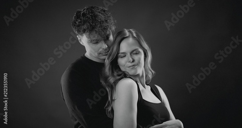 Принти на полотні Happy couple embracing with love and closeness in a studio portrait