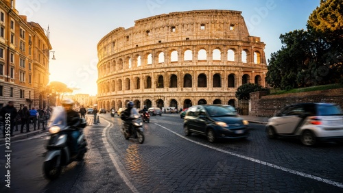 Rome Colosseum long exposure travelling images at sunset with motion blur on city street and traffic, historic stone amphitheater in urban scene