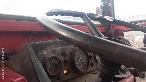 Vintage tractor dashboard with non-functional gauges and close-up of steering wheel revving sounds