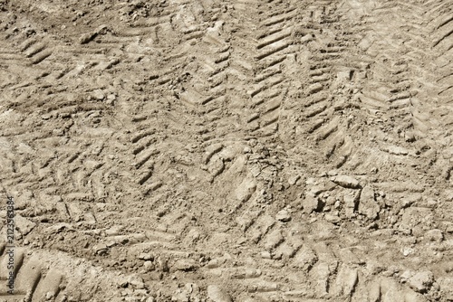 Tire tracks on an earth soil ground texture