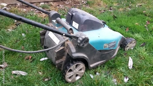 Cordless lawn mower starts running smoothly over grass with a consistent whirr of engine and blades in action