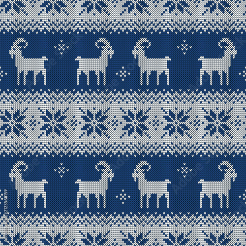 Knitted seamless pattern for 2027 New Year of the Goat. Vector background with cute goats and scandinavian ornaments. Blue and white sweater print.