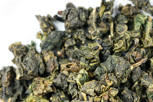 Dried tea leaves on white background, studio macro