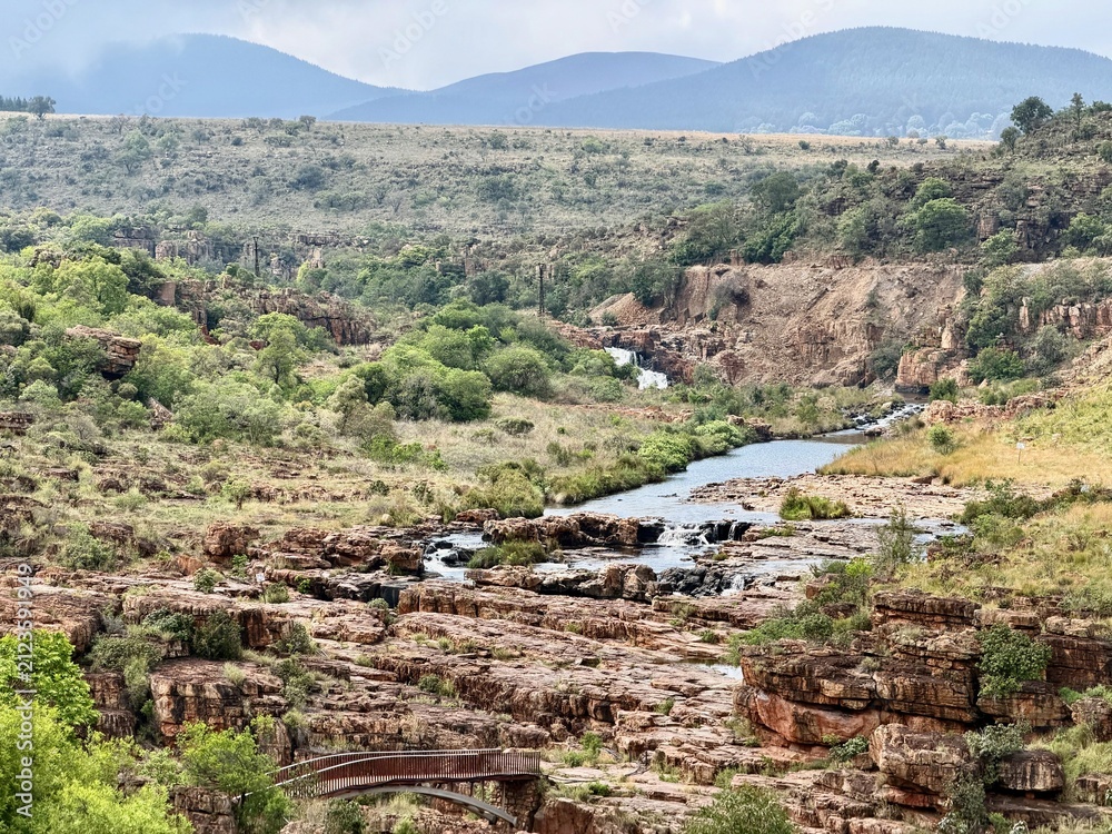 Fototapeta premium Bourke's Luck Potholes near Graskop, Mpumalanga, South Africa, featuring rocky outcrops and a wooden bridge