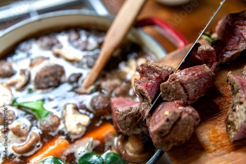 Fotografie Sliced beef and vegetables in a pot, ready for a hearty stew.