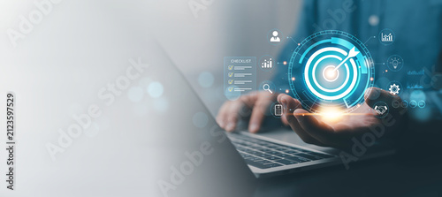 Business goal achievement concept with digital target, checklist and analytics on laptop, illustrating strategic planning, performance management, success, growth, productivity, measurable results.