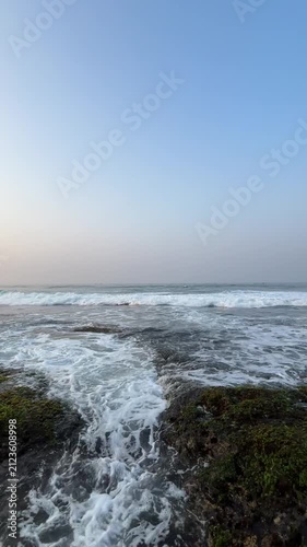 Pan View of Rocky Tropical Coastline with Ocean Waves and Tide Pools