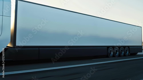 Electric truck drives on a highway during daytime with clear sky
