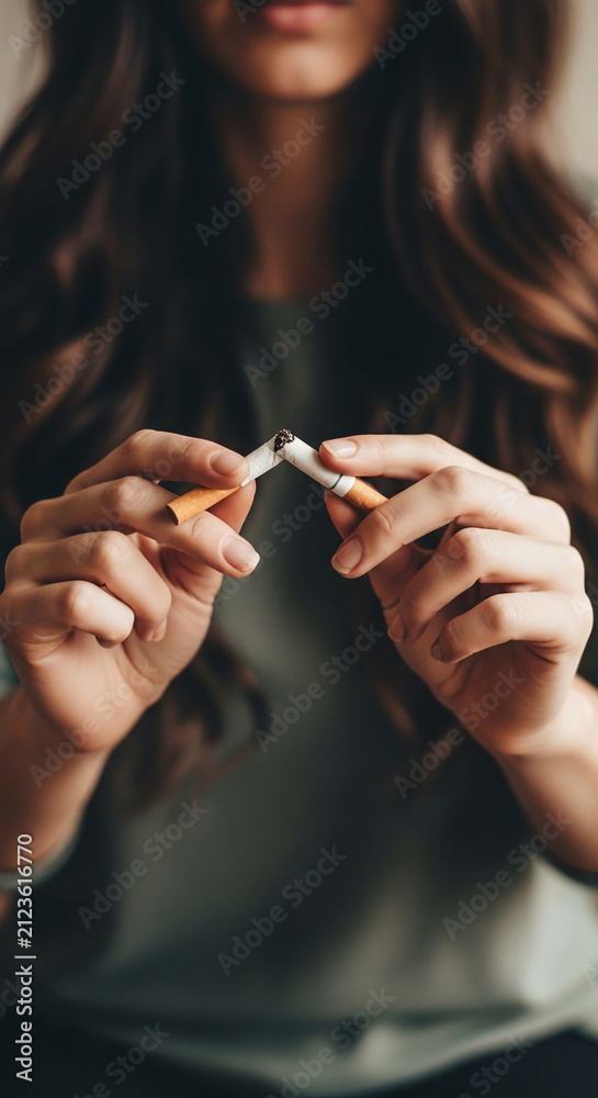 Obraz premium Person breaking cigarette in half, symbolizing quitting smoking and healthy choice. Concept for health and wellness.