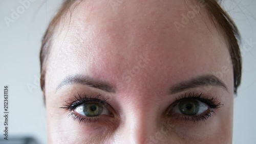 The woman had a botulinum toxin procedure. She has no wrinkles on her forehead. The girl raises her eyebrows.