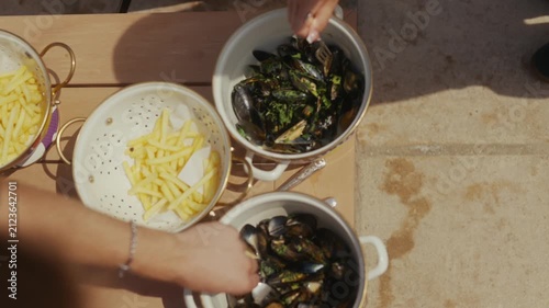 Close-up of mussels and fries on a table in a seaside restaurant