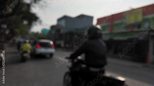motorcycle and car on the road, blurry view