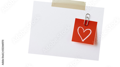 Obraz na płótnie White paper note with red heart sticker attached by paperclip, isolated on trans