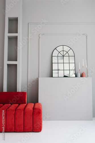 Arched Mirror above Fireplace and Red Sofa