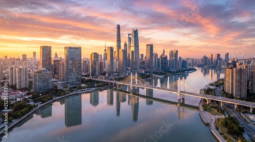 Panoramic View of Modern City Skyline Along Riverbank at Sunset