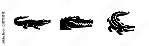 Alligator and crocodile icon set. Wild reptile in profile, head, and aggressive pose, black silhouette illustration.