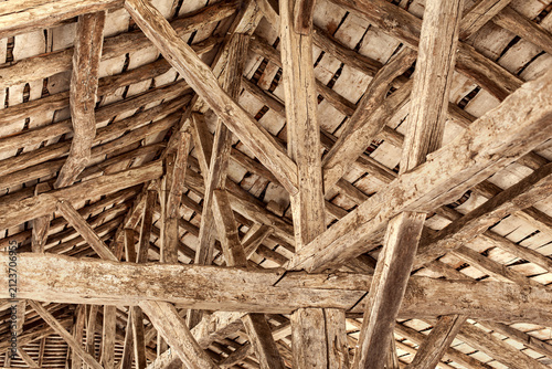 Close-up of oak beams heavily weathered to a silvery-grey patina.