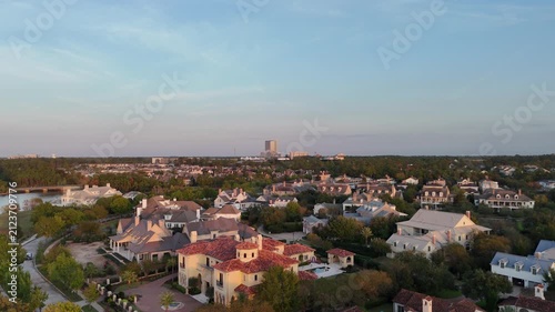 Aerial view of large mansion houses, in affluent neighborhood by Woodlands lake, Houston, Texas, expensive suburban houses by sunset, USA