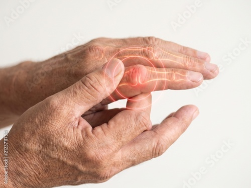 Elderly person experiencing joint pain in hand with highlighted inflammation.