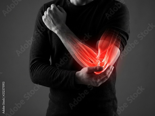 Man holding elbow with glowing red inflammation indicating pain and injury.