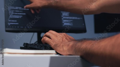 Software Engineer Hands Working on Computer Keyboard, Reviewing Code and Developing AI Software Application in Nighttime Office.