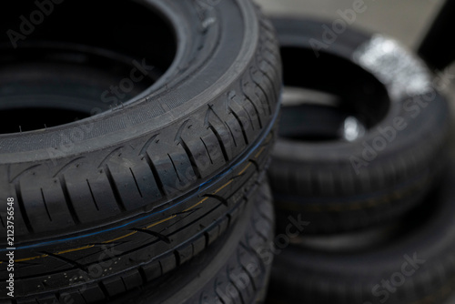 Stacked new car tires in automotive workshop