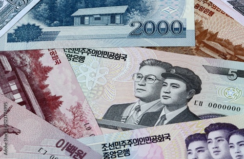 North Korean won money bills in pile on table. North Korea KPW currency cash close up