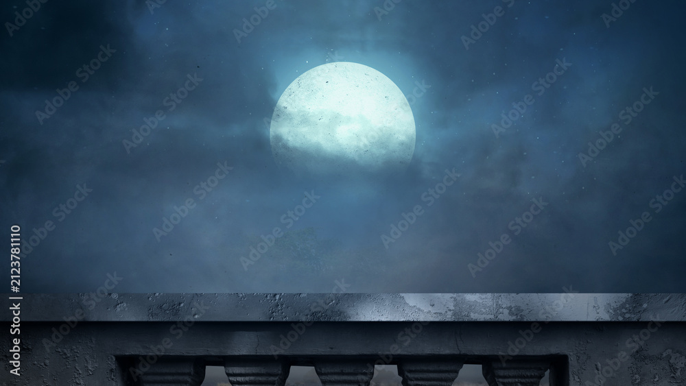 Fototapeta premium A view from a stone balcony looking out at a bright full moon shining through dramatic, moody night clouds in a dark blue sky. Halloween background