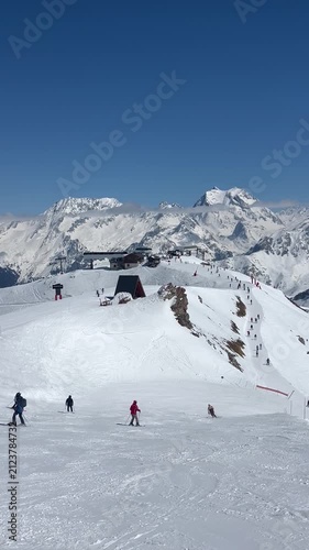 Skiers on the slopes of Courchevel ski resort by winter 