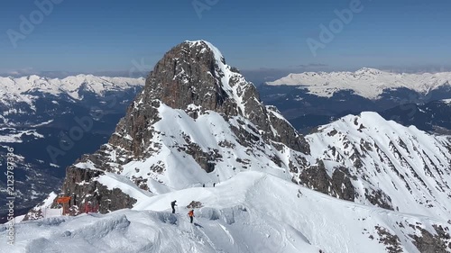 Skiers at the peaks of French alps by winter under snow 