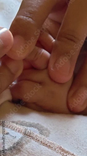 Video of Soft hands cradle tiny fingers, tender touch. Warmth, comfort, care, connection, new life. Ideal for parenting, bonding, newborn, family, love. Footage shows bonding between babies and parent