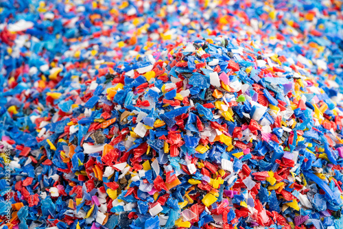 Fotografie Plastic colorful pieces recycling shredded for industrial use.