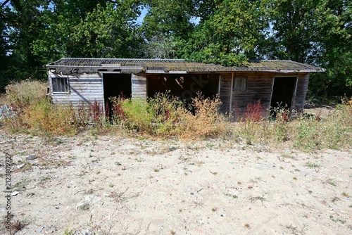 Abandoned ramshackle stables in Surrey in the midday heat during August 2026.