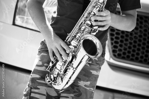Obraz na plátně street musician playing saxophone black and white