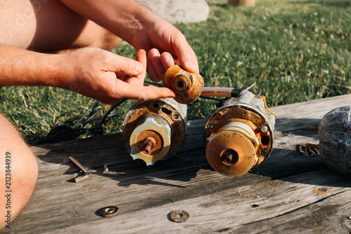 Принти на полотні Hands holding worn rubber impeller during submersible water pump repair