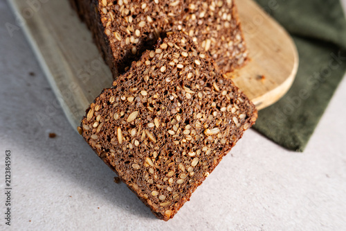Close-up texture of sliced dark Danish rugbrød or rye bread loaf.