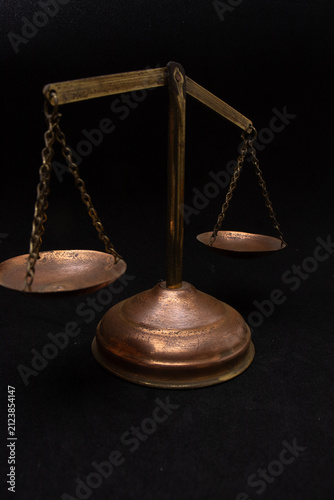 front view of a justice scale with a black background