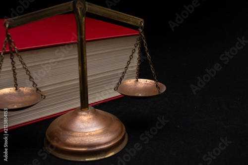 top view of a justice scale with a book beside it