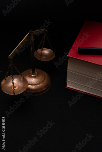 top view of a justice scale with a book beside it
