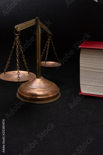  view of a justice scale with a book beside it