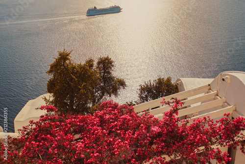 Quadro su tela Beautiful view of pink bougainvillea flowers on traditional white terrace overlo