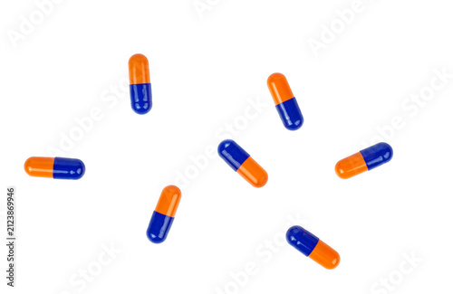 Pile blue oorange pills isolated on a white background.Top view