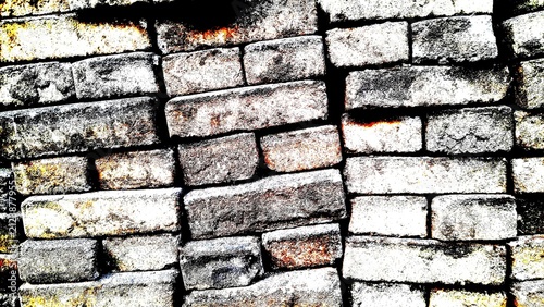 High contrast abstract texture of stacked old weathered bricks wall background with high gritty grain.
