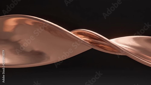 A close-up of a brushed metallic surface with warm, coppery tones and subtle highlights
