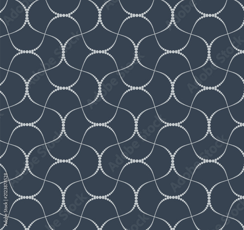 Seamless vector pattern of delicate dotted wavy lines forming an abstract geometric mesh on a dark charcoal blue background. Elegant tile for textile and wallpaper.
