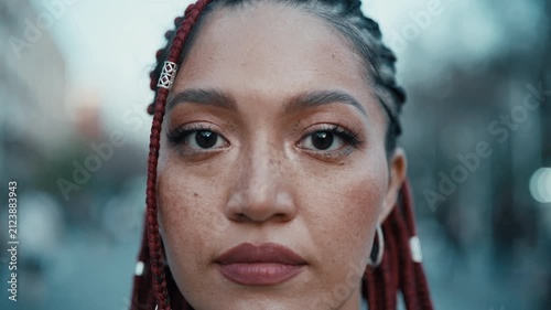 Woman with red braids and natural makeup in urban street setting