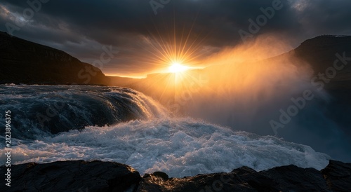 Dramatic sunrise over a powerful waterfall, casting golden light