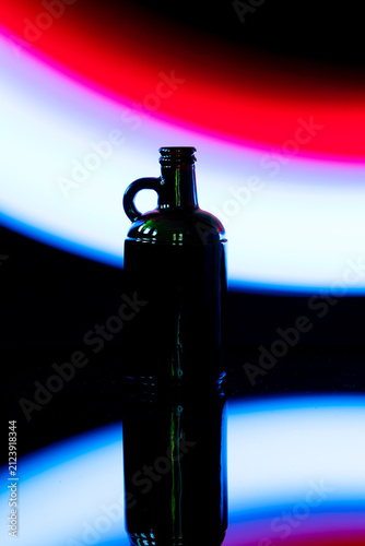 bottle silhouette, glass bottle, bokeh, neon light, abstract background, colorful, red, orange, blue, teal, nightlife, light photography, low key, dark, mysterious, artistic, blur, bokeh lights, color
