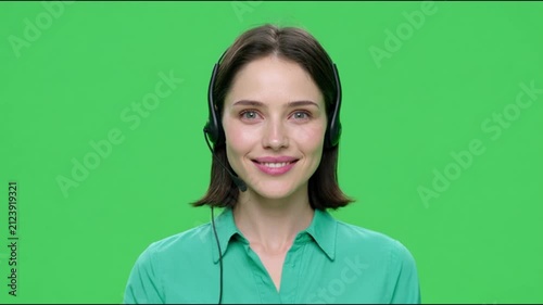 Customer service representative with headset smiling against green screen background